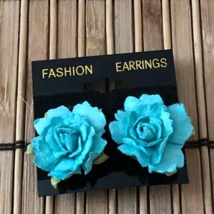 Two pairs of light blue flower post earrings.